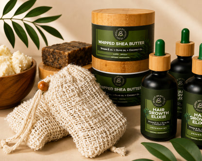A set of hair care products from the brand '2' arranged on a beige surface with natural props. The set includes a jar of Whipped Shea Butter with a bamboo lid, two bottles of Hair Growth Elixir with green dropper tops, a beige mesh cleansing pouch, and a bar of shampoo.